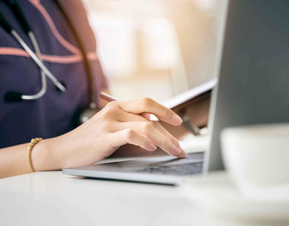 Healthcare professional at laptop