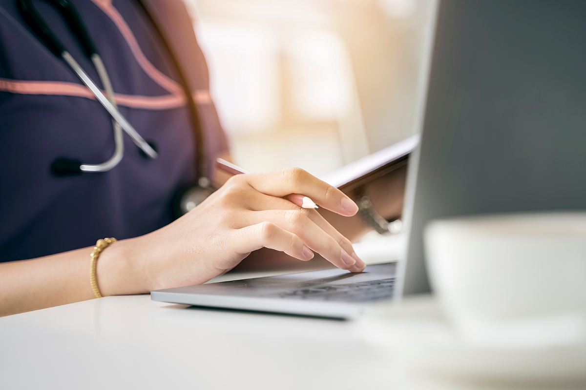 Healthcare professional at laptop