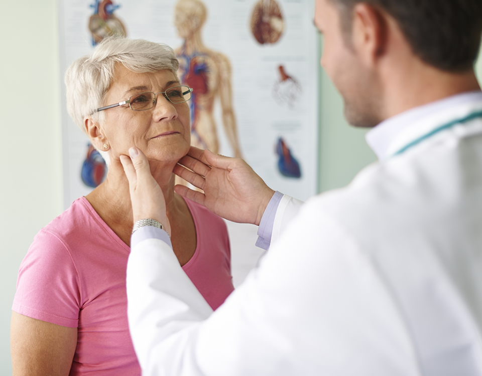 Doctor examining patient's neck