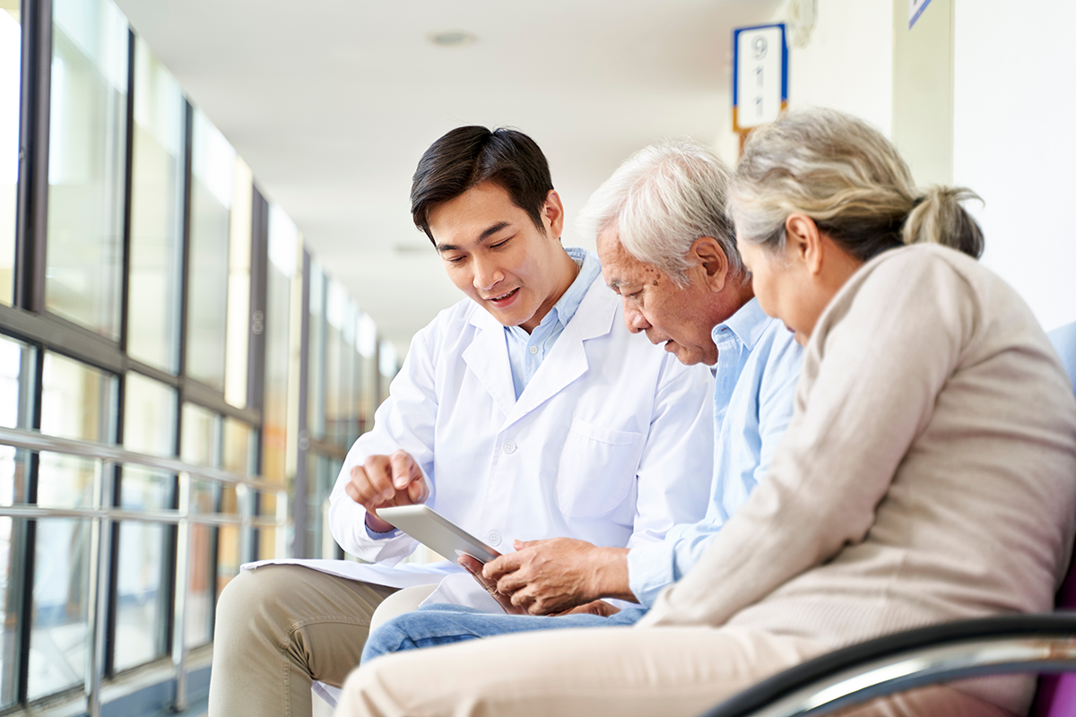 Doctor speaking with couple