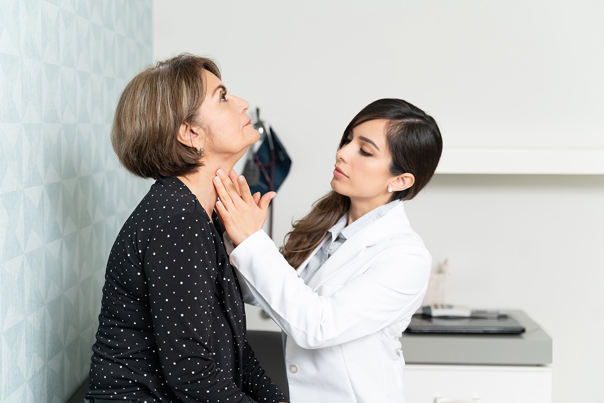 Doctor feels patient's throat
