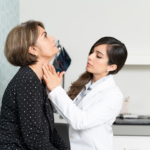 Doctor examining patient's neck