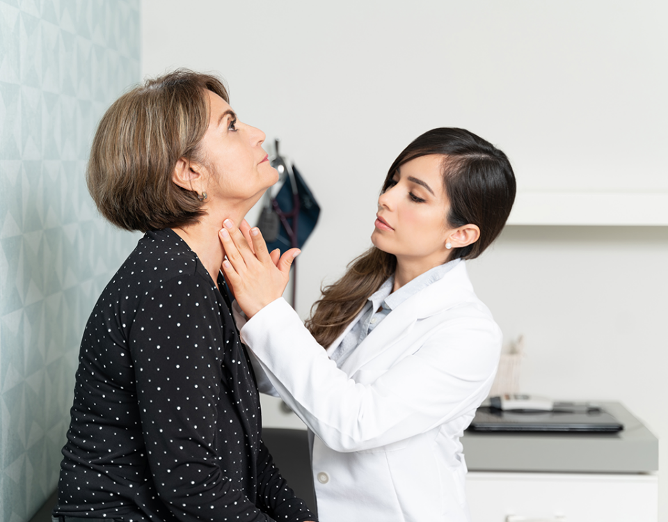 Doctor examining patient's neck