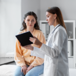 Patient with doctor reviewing tablet