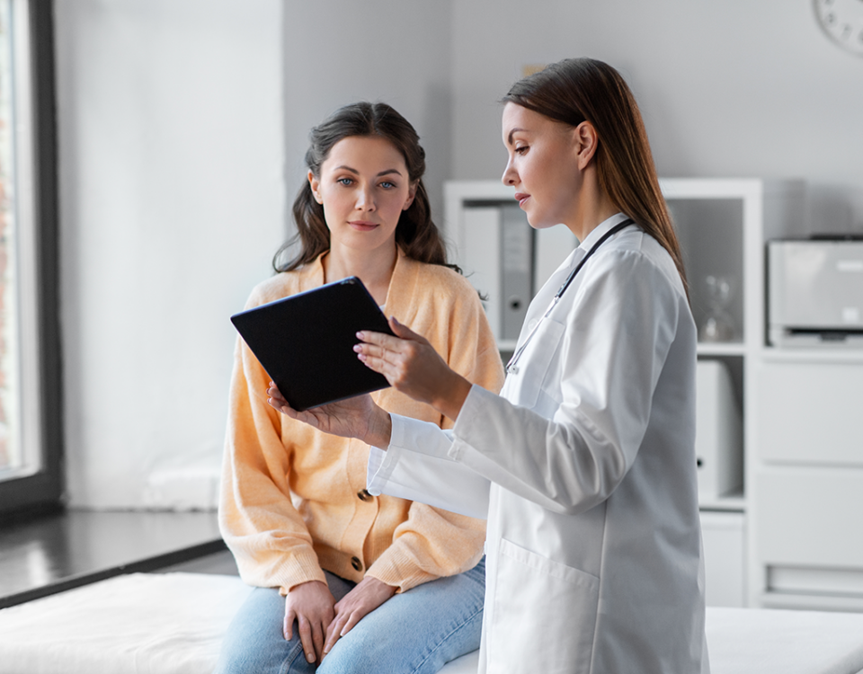 Patient with doctor reviewing tablet
