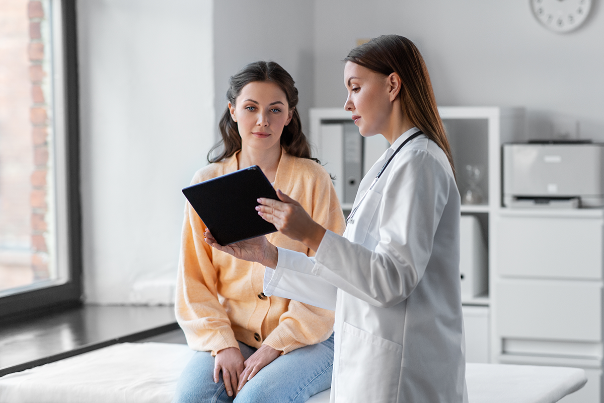 Patient with doctor reviewing tablet
