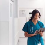 Female doctor in scrubs on iPad