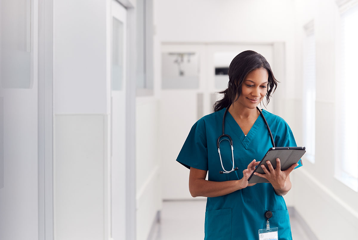 Female doctor in scrubs on iPad